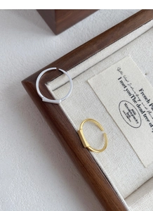 Detail of adjustable gold and silver minimalist rings with rectangular metal accents