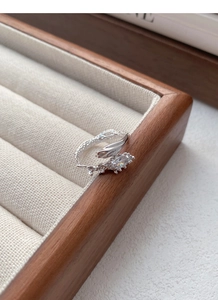 Macro view of S925 sterling silver snake ring with marquise zircon on wood box