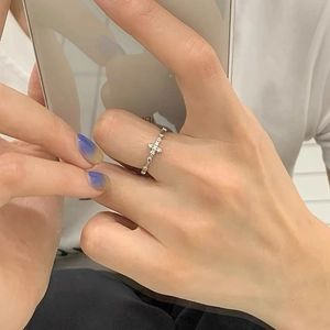 Minimalist S925 sterling silver cross ring with cubic zirconia stones on female finger