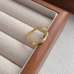 Elegant gold S925 silver bamboo ring with brushed metal texture and sparkling zircon