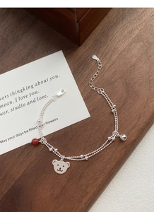 Close-up of S925 silver double-layer bracelet with red agate beads and cute bear charm