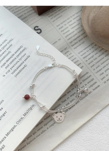 Macro detail of S925 sterling silver stamp on double-layer bear and red agate bracelet