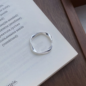 Elegant S999 sterling silver Mobius loop ring with a polished minimalist open design