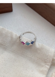 Close-up of S925 silver ring featuring colorful clover motifs and sparkling zircon accents