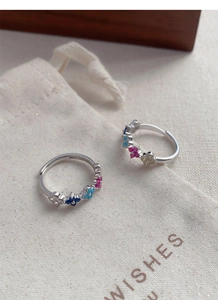 Close-up of S925 silver adjustable rings with colorful zircon four-leaf clover charms