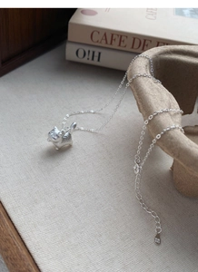 Detail of S999 pure silver kitten pendant showing matte texture and fine chain craftsmanship
