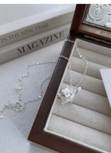 Detail of S999 silver cat pendant with textured back in a premium jewelry box