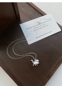 Detail of S999 silver cat pendant with matte finish on a delicate cable chain