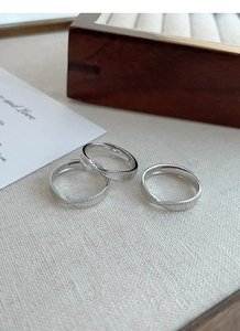 Macro shot of S925 sterling silver twist ring set with delicate beaded edge detail