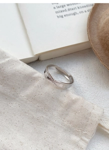 Detail of S925 sterling silver twisted ring with beaded texture and wave design
