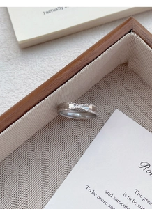 Close-up of S925 sterling silver ring showing twisted design and hallmark stamp