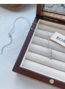 Détail macro d'un pendentif en diamant brillant sur une chaîne fine en argent fin