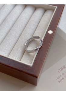 Detail of S925 sterling silver twisted ring showing the S925 hallmark on inner band