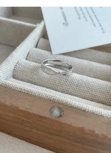 Detailed close-up of S925 sterling silver twisted ring with hallmark and textured finish