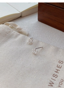 Macro détaillée de boucles d'oreilles fleurs ajourées en argent sterling S999