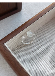 Detail of S925 sterling silver ring featuring a white chalcedony bud and cat paw design
