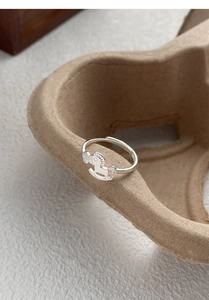Macro shot of S925 sterling silver ring with delicate rocking horse motif and hollow design