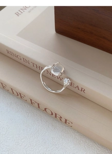 Detail of S925 silver ring with irregular texture and translucent chalcedony stone