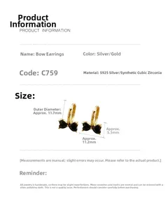 Detailed view of gold S925 silver bow earrings with dark heart-shaped cubic zirconia