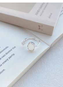 Detail of S925 silver ring with white chalcedony bud on minimalist open band