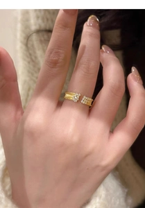 Detail of vintage style gold brushed ring with clustered sparkling zircons on model hand