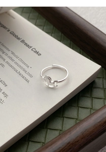 Macro view of S925 sterling silver rocking horse ring on vintage book pages