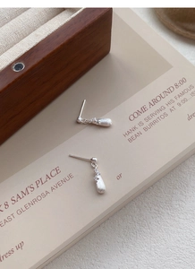 Close-up of S925 sterling silver water-drop earrings with brushed texture and zircon inlay