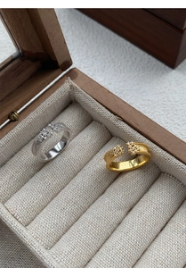 Detailed macro view of S925 silver and gold starry rings with zircon inlays and beaded edges