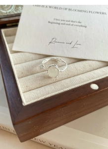 Detail of S925 silver irregular ring with yellow chalcedony bud in a wooden jewelry box