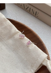 Macro shot of S925 sterling silver stamp on pink zircon stud earrings with four-prong setting