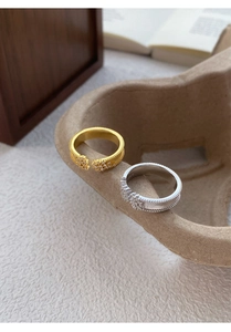 Detailed view of S925 sterling silver milgrain rings with zircon stones in gold and silver