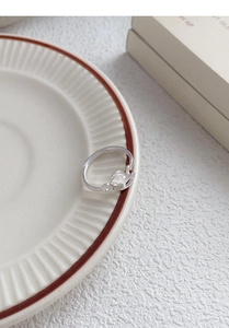 Detail of S925 silver adjustable ring featuring a cute cartoon horse on white ceramic plate
