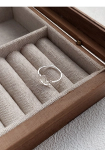 Detail of S925 silver horse ring with hollow rocking horse on wooden jewelry box