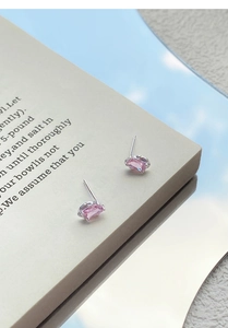 Close-up of S999 silver earrings featuring rectangular pink cubic zirconia stones