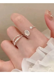 Detail view of silver S925 ring with white chalcedony bud and textured irregular design