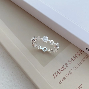 Elegant S925 sterling silver ring with oval cubic zirconia on a minimalist white card