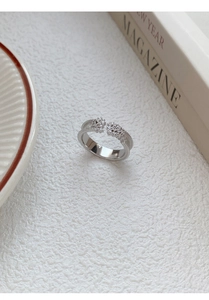Macro shot of silver S925 flower ring with cubic zirconia stones and beaded edge