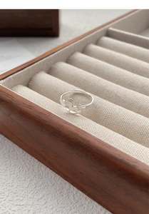 Macro detail of S925 sterling silver rocking horse ring on a beige velvet gift display
