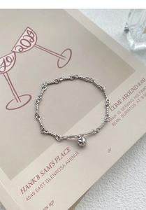 Detail of S999 silver twisted rope bracelet with a ribbed pumpkin charm pendant