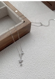 Macro shot of silver star necklace pendant with sparkling zircons on jewelry box