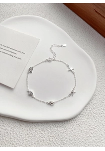 Detail shot of S925 sterling silver ocean charm bracelet with starfish and shell pendants