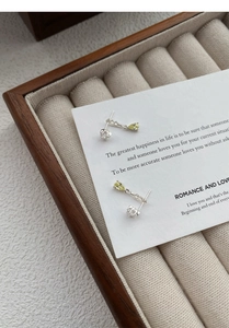 Detail of silver drop earrings with yellow zircon crystals in a luxury velvet gift box