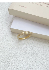 Close-up of S999 sterling silver cat paw ring with dual-tone finish on book edge