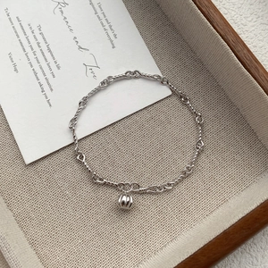 S999 Sterling Silver Pumpkin Charm Bracelet with vintage twisted chain in a romantic setting