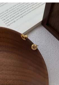 Detail of S925 silver asymmetric earrings with matte gold Pixiu and coin design