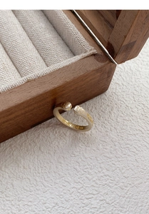 Detailed shot of golden cat paw ring featuring engraved Chinese lucky characters on inner band