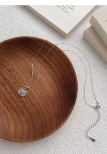 Detailed view of S925 sterling silver long-life lock pendant with Fu character relief