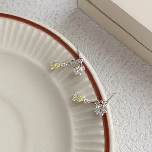 S925 silver star drop earrings with square zircon and yellow gemstone in a ceramic dish