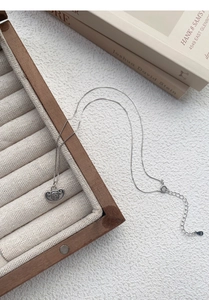 Macro view of S925 sterling silver lobster clasp and tail chain on Ruyi lock necklace
