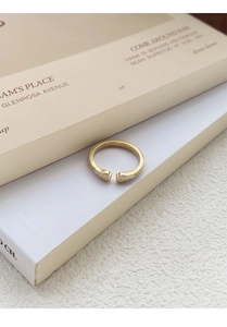 Detailed macro view of gold-plated cat paw open ring with frosted matte finish